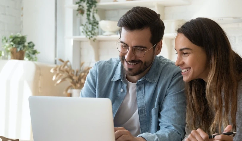 Couple reviewing financing options on a laptop
